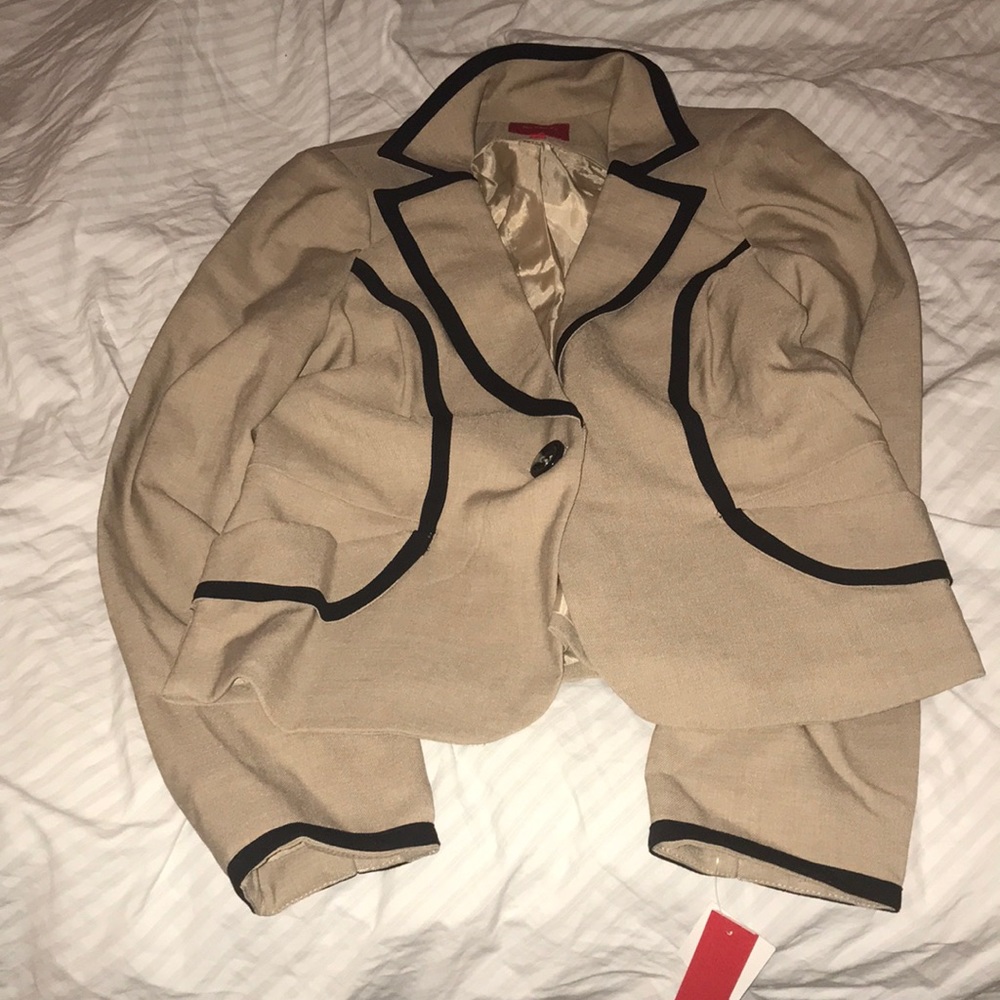 A junior’s khaki blazer with black detailed trim.